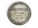 a close up of a silver coin on a white surface