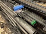 a pile of steel pipes sitting on the ground