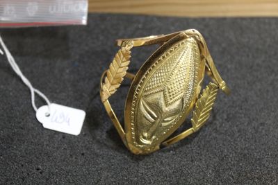 an image of a gold ring sitting on top of a table