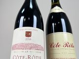 two bottles of wine sitting next to each other on a table