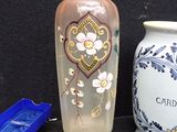 two vases sitting next to each other on a black surface