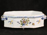 a white bowl with blue and yellow flowers on it