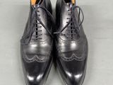 a pair of black leather shoes with laces on them