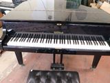 a piano that is sitting next to a chair