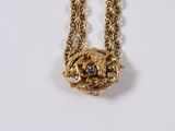 gold plated necklace with black and white stones on a chain