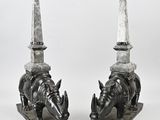 two statues of rhinos with a knife on top of them