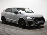 a grey audi suv parked on a checkered floor