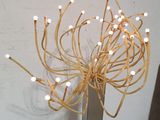a tall vase with a bunch of lights on top of it