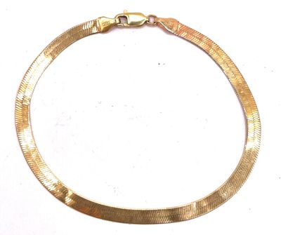 a close up of a gold necklace on a white surface
