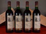 three bottles of wine sit on a table next to a wooden box
