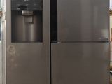 two refrigerators that are sitting in a kitchen