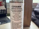 a bottle of cerammik on a table next to a box