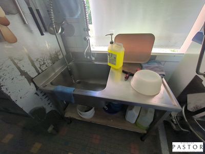 an image of a kitchen with a sink and a window