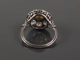 a close up of a diamond ring on a black surface