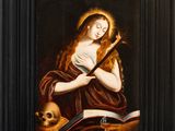 an oil painting of a woman holding a book and a skull