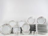 a lot of plates that are stacked together on the table