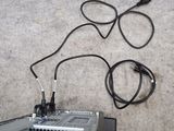 a black box with wires attached to it sitting on the floor