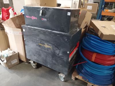 boxes and hoses are stacked on top of a cart in a warehouse
