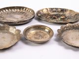 six silver plated dishes and bowls on a white surface