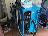 a blue machine that is sitting in a garage