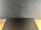 a laptop computer sitting on top of a wooden table