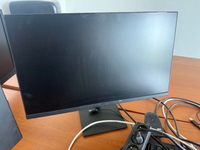 un écran d'ordinateur posé sur un bureau en bois