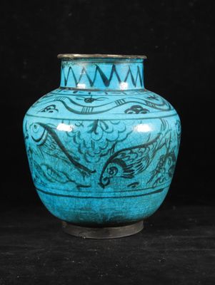 a blue vase sitting on a black surface