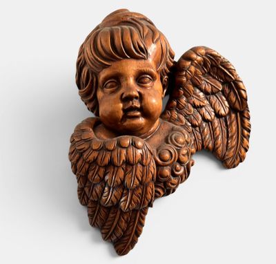 a close up of a small statue of an angel on a white background