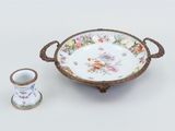 a bowl and a cup sitting next to each other on a table