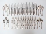 a lot of silver spoons and forks on the table
