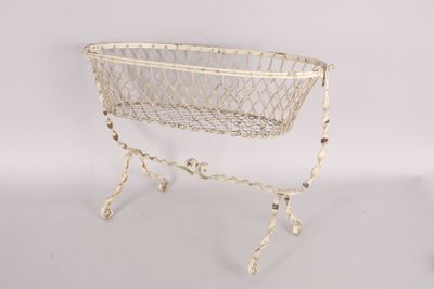 an old white wire basket on a stand on a white background