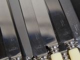 a lot of knives that are sitting on a table