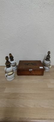 a small wooden box sitting on a table next to two small vases