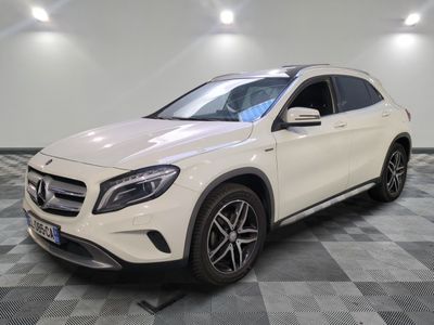 a white mercedes gla suv parked on a checkered floor