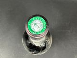 a close up of a metal sink with a green lid
