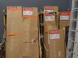 boxes are stacked on pallets in a storage room with a ladder