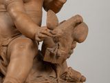 a statue of a baby sitting on top of a table