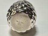 a close up of a silver object on a white surface