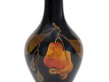 a black vase with a picture of a pear on it
