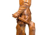 wooden statue of a boy with a dog on a white background