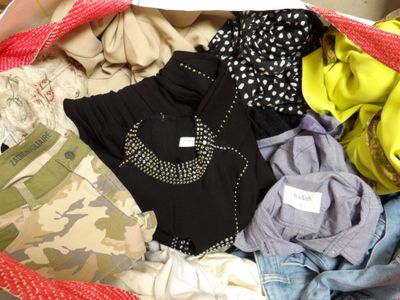 a bag full of clothes that is sitting on the floor
