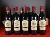 six bottles of red wine are lined up on a table
