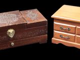 two small wooden chests sitting side by side on a black background