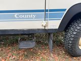 a white truck with a blue stripe on the side of it