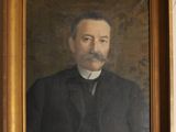 portrait of a man in a black coat and a white collared shirt