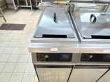 two stainless steel stoves in the kitchen of a restaurant