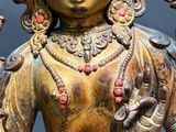 a statue of a woman holding a bird in her hand