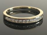 a close up of a diamond ring on a black surface