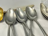 five spoons and a spoon knife on a table