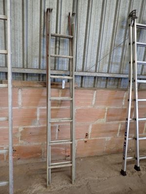 two ladders that are leaning against a wall